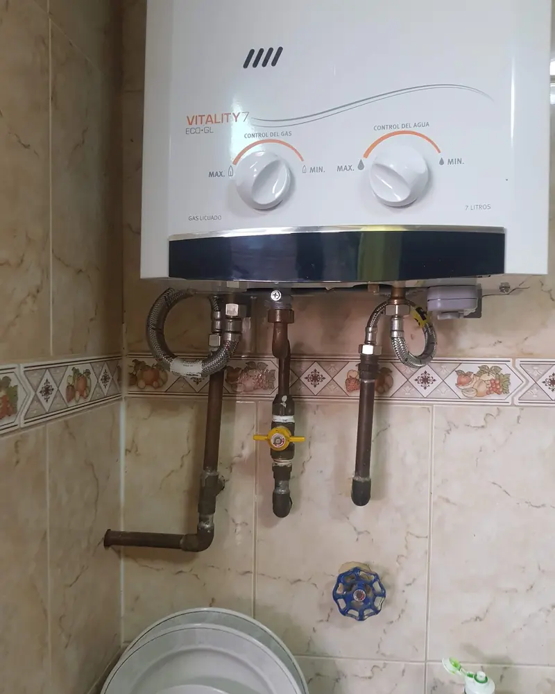 Calefont instalado con cañerías de cobre y llaves de paso bajo él