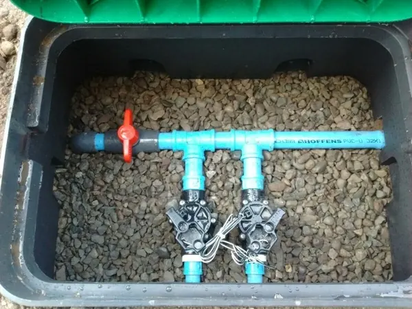 Dos electroválvulas dentro de una caja con gravilla para drenar